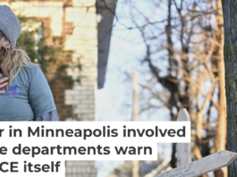 A protester stands near a makeshift memorial honoring Renee Nicole Good, the victim of a fatal shooting in Minneapolis involving federal law enforcement agents. AP Photo/Tom Baker